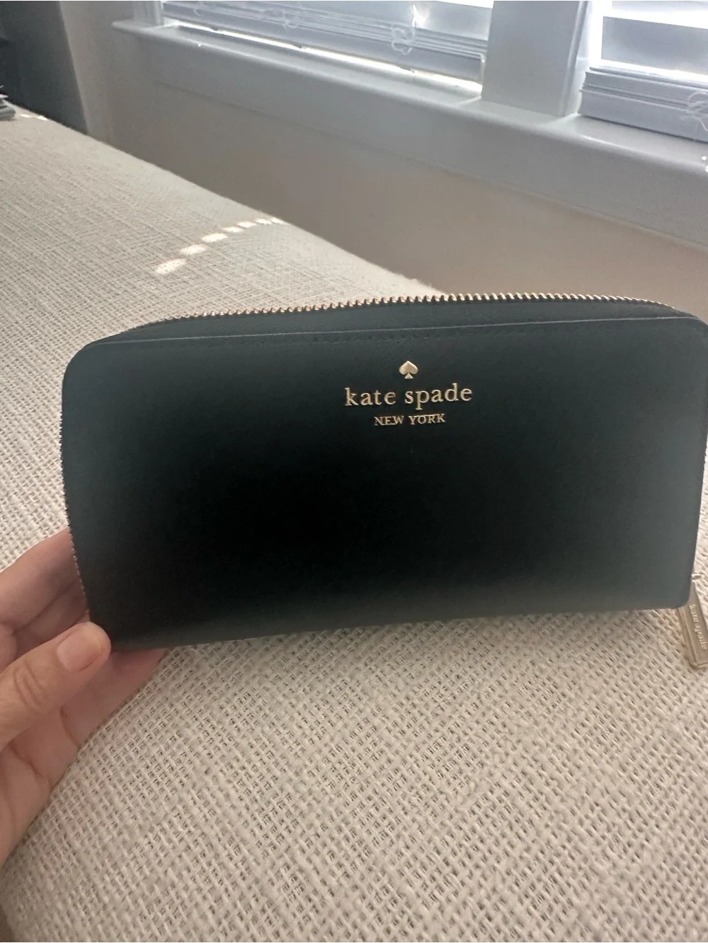 kate spade black Saffiano zip-around wallet with gold logo